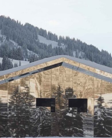 Mirror building reflecting the forest and snowy mountain