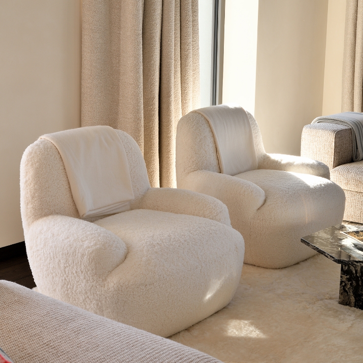 Pair of curly white Bao armchairs by Norki in an elegant living room