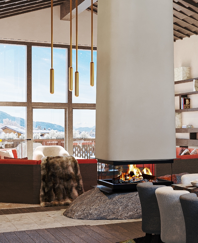 Living and dining area of a chalet with design fireplace and mountain view