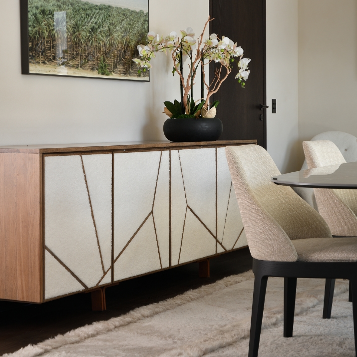 Designer wooden sideboard with textured white fronts and geometric brass inlays by Norki