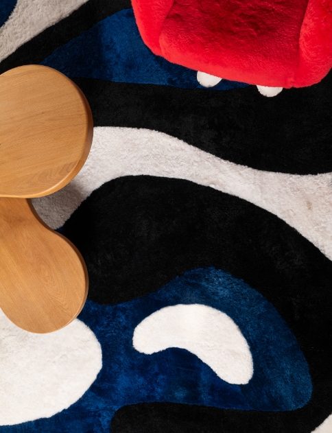 Abstract colorful rug in red, blue, black, and white