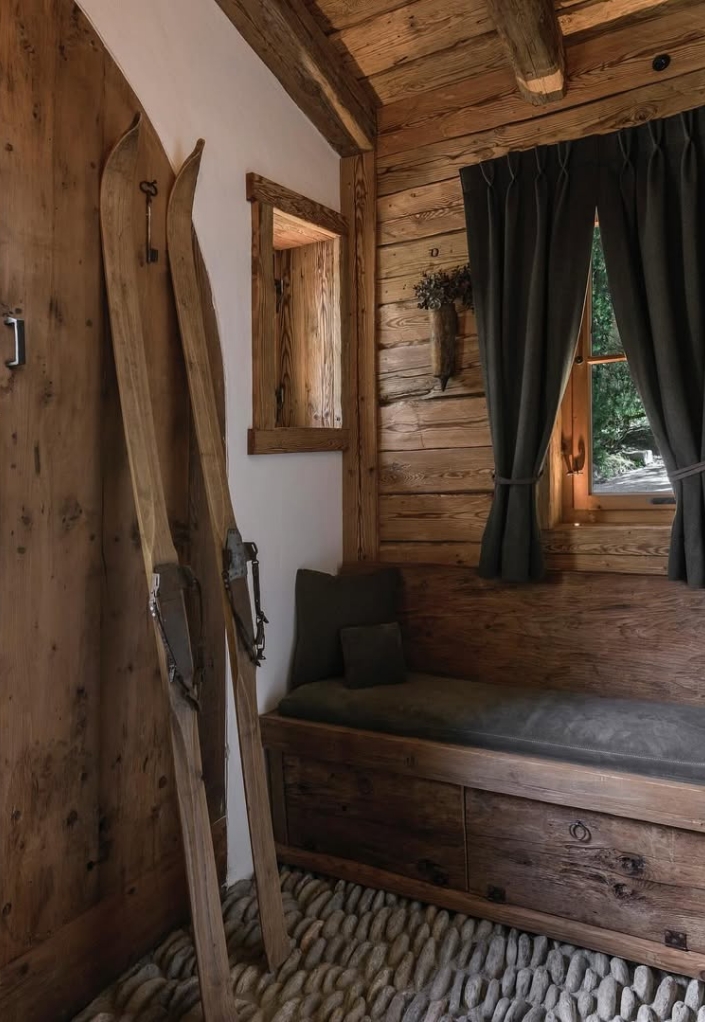 Wooden chalet interior with vintage skis and bench