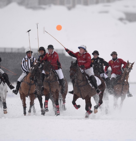 Polo players on horseback in the snow