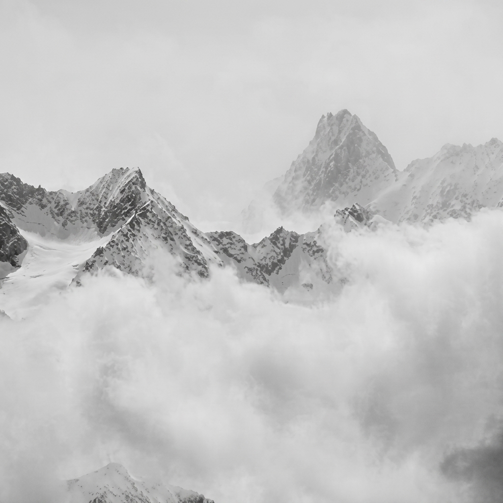 Mountain landscape with peaks in the clouds