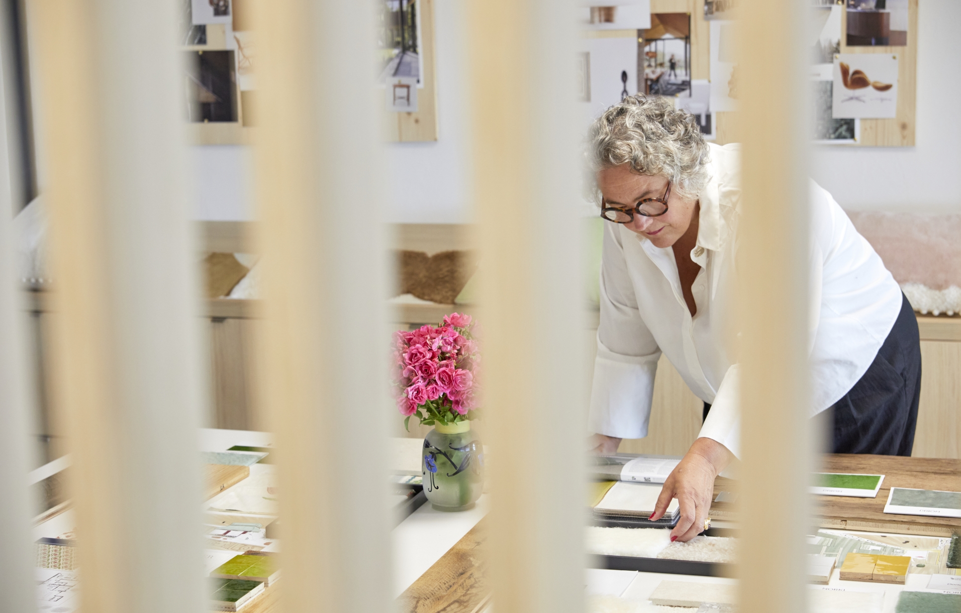 Sonia Linard working on a moodboard of material and color samples