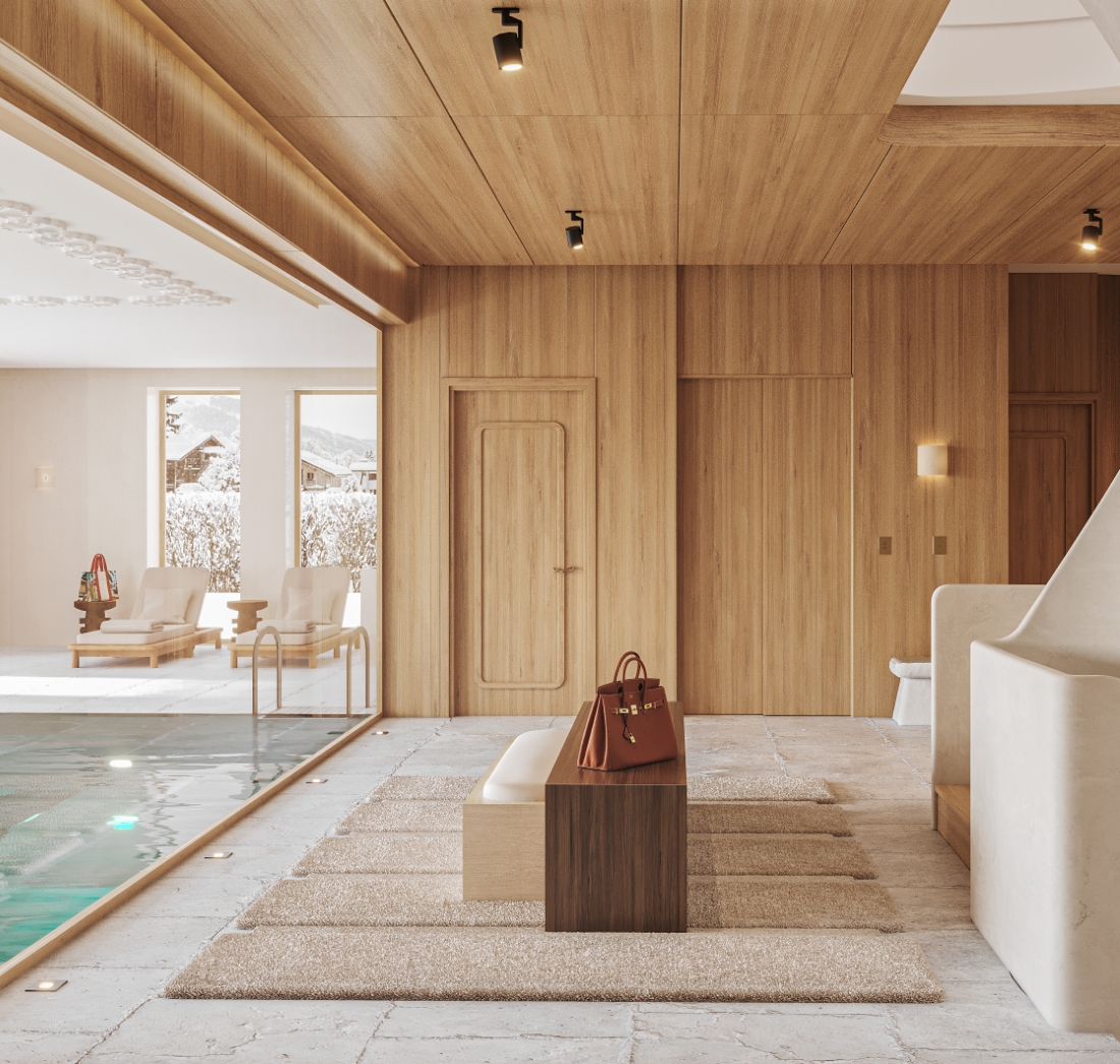 Vaste espace intérieur de chalet avec piscine intérieure, transats et vue sur les sommets enneigés, habillé de bois clair