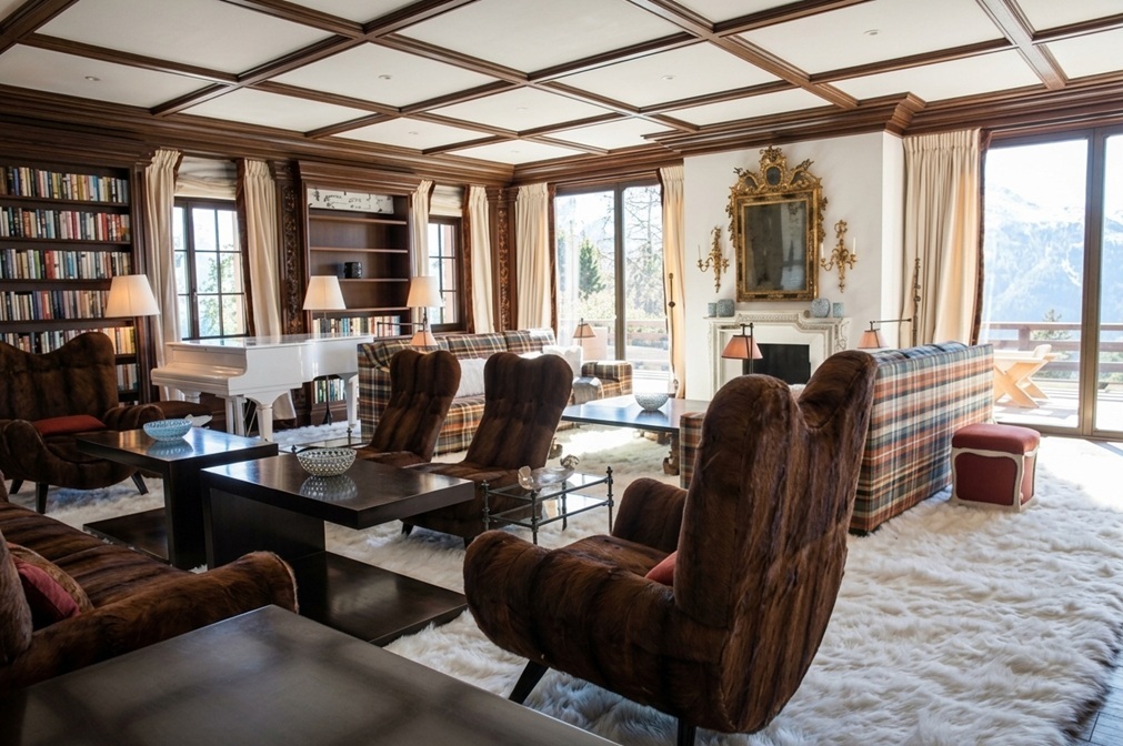 Main living room of the St. Moritz chalet with monumental white fox rug and Jean Royère furniture